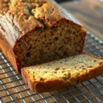 Moist zucchini banana bread loaf cooling on a rack